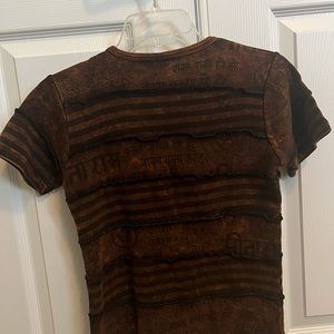 Women’s shirt in a dark brown-reddish color. Size medium. Lightly used.